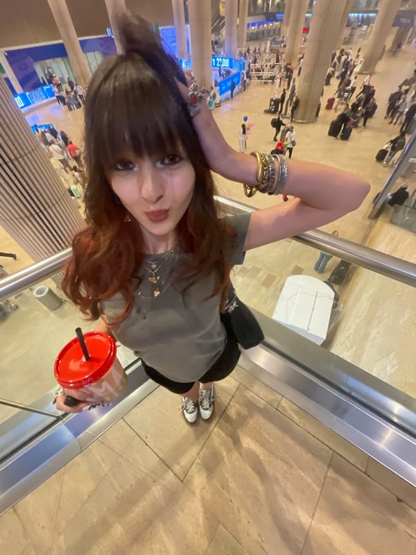 Young women take playful selfies in Israeli airport terminal