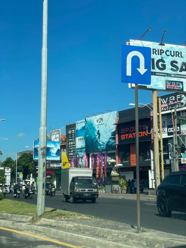 Morning motorcycle commute through busy Kuta streets documented