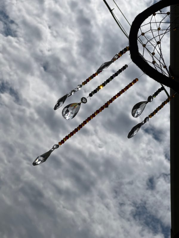 Dreamcatchers hanging outdoors against Chemal's mountain sky