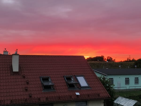 Vivid sunset over red-tiled rooftops in Tczew, Poland
