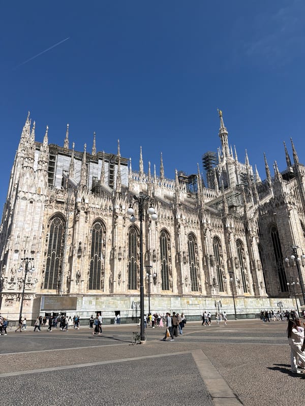 Milan visitors document cathedral architecture and outdoor dining experiences