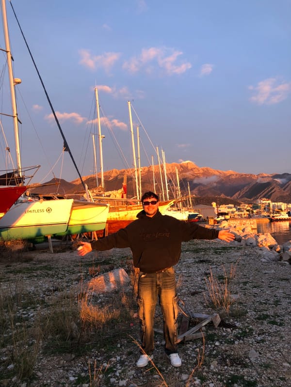 Person celebrates sunset moment at Bar Montenegro marina