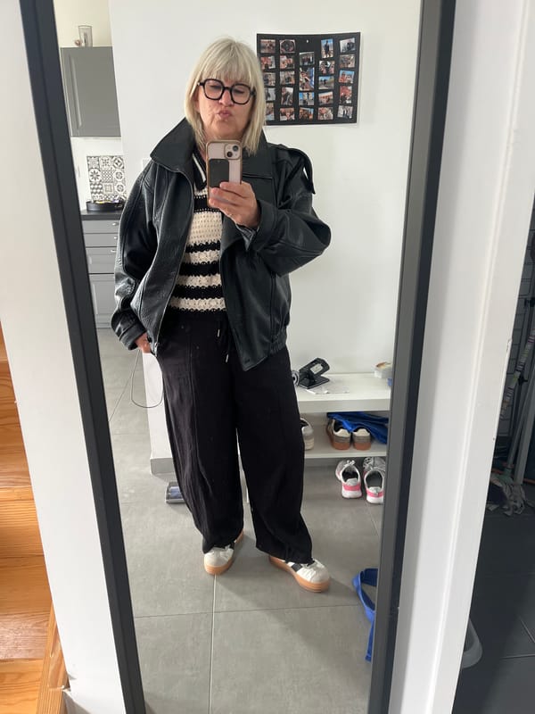 Woman takes bathroom mirror selfie in Chambœuf, France