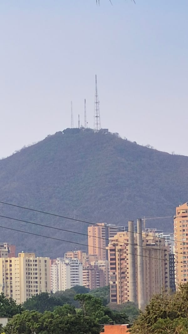 Valencia cityscape captured with mountain backdrop and communication towers