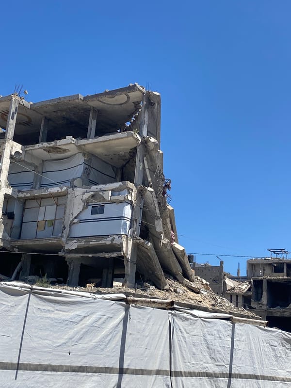 Child with drum amid Gaza building debris, May 7