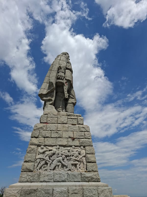 Tourist photographs Alyosha Monument from multiple angles in Plovdiv