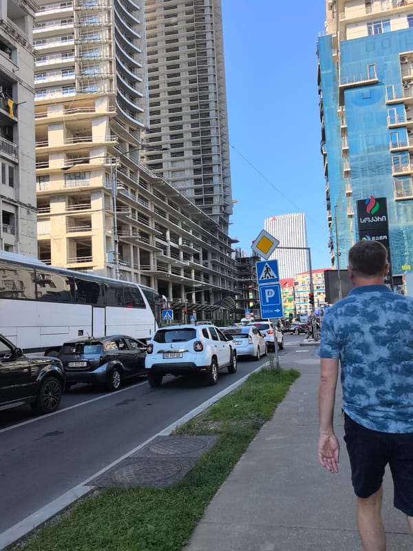 Pedestrians and construction define a busy urban stretch