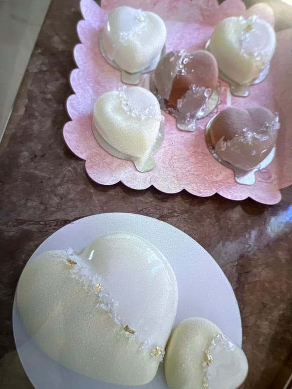 Desserts, chocolates, and flowers arranged together