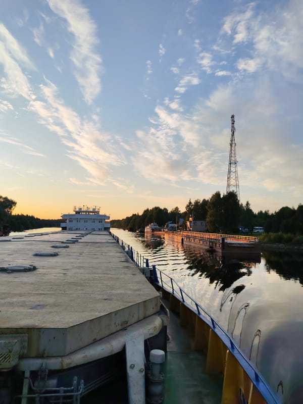 Barge moored on a calm Russian river at sunset