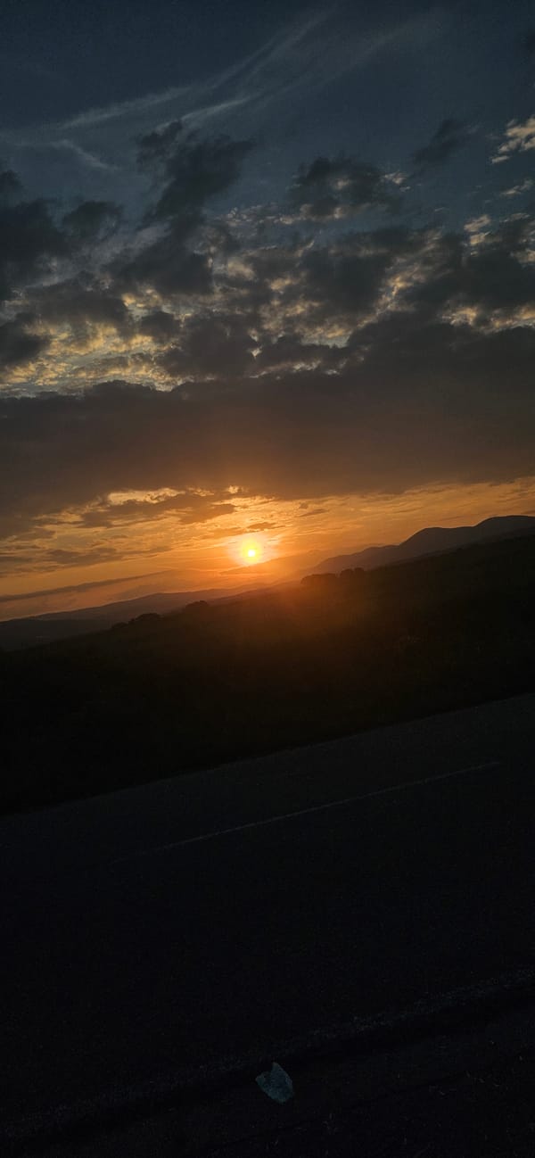 Sunset observed across rural Bulgarian mountain pass landscape