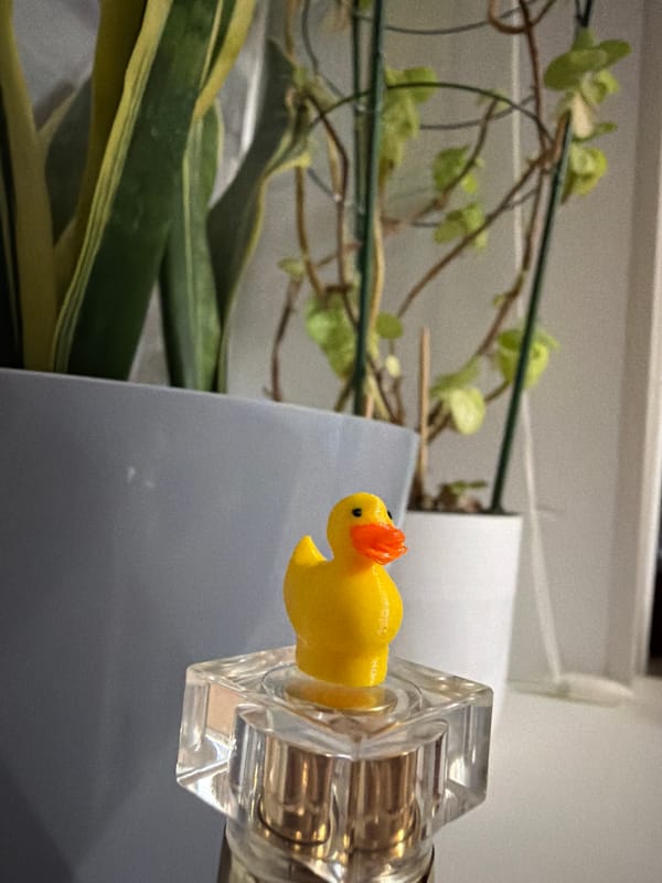 Yellow rubber duck photographed with glass bottles in Tujmazy