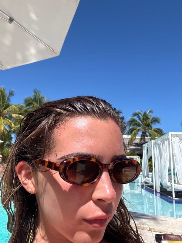 Woman reads poolside at Dominican Republic resort