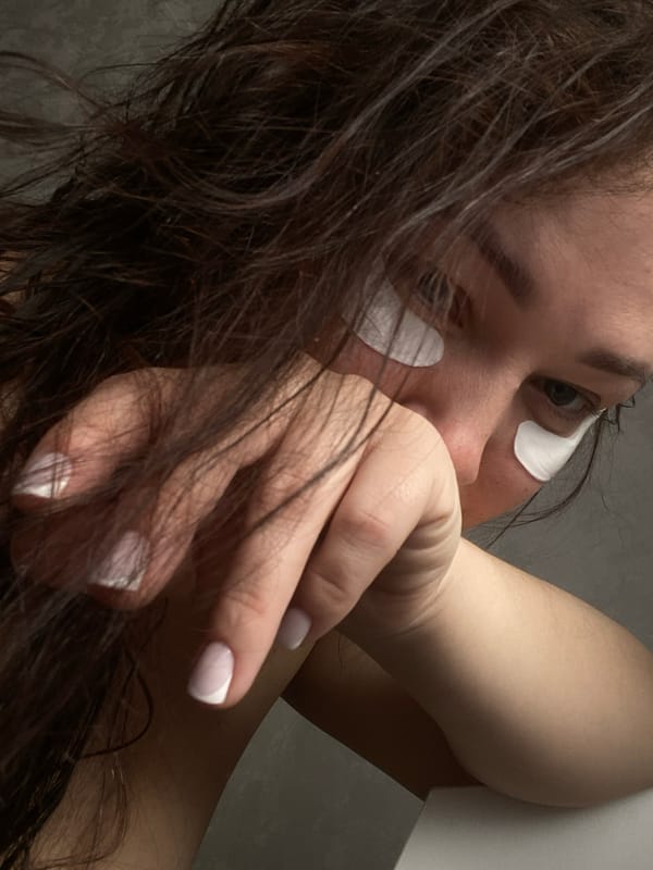 Woman documents skincare routine with eye patches in Sochi