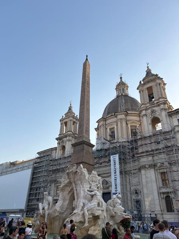Piazza Navona's iconic fountain and obelisk on a sunny afternoon