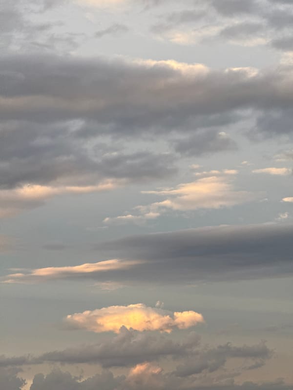 Dramatic golden-lit clouds observed over city skyline