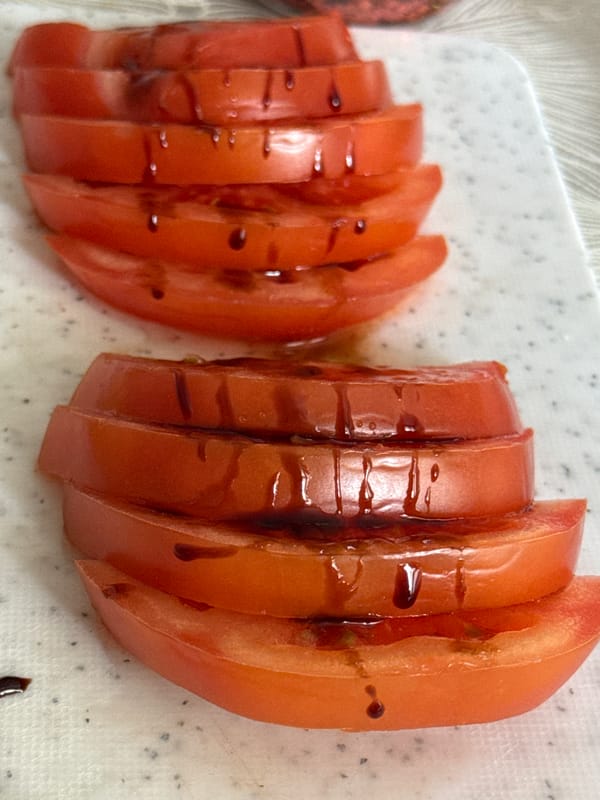 Sliced tomatoes with balsamic glaze documented at unknown location