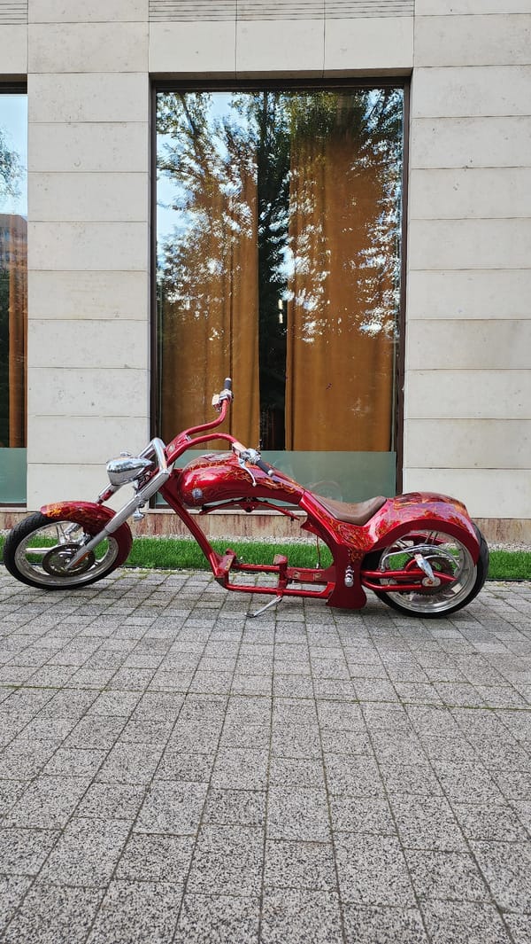 Custom red chopper parked near Moscow's modern waterfront district