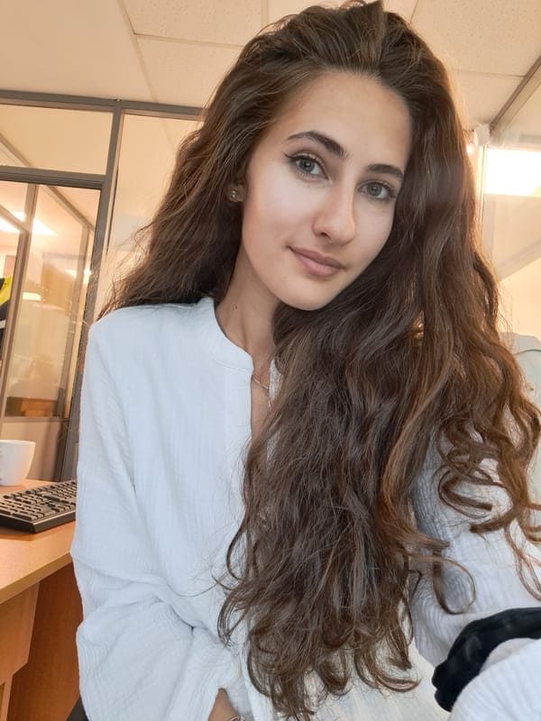 Woman poses playfully in Sofia office setting