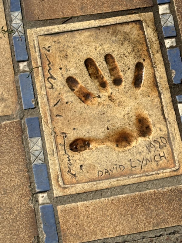 Tourist examines David Lynch handprint on Cannes celebrity walkway