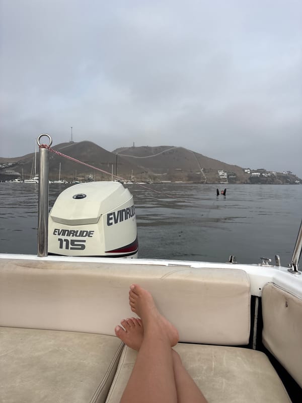 Person relaxes on boat in Ancón Bay, Peru