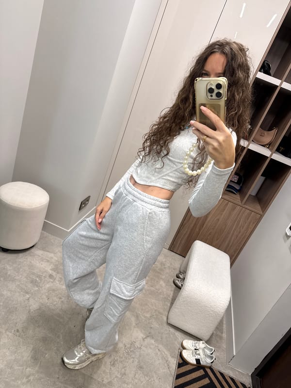 Mirror selfie in a Moscow dressing room, grey coord outfit.