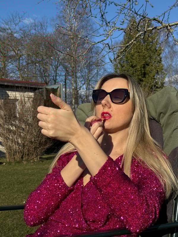Woman in pink sequined dress poses with gardening tools
