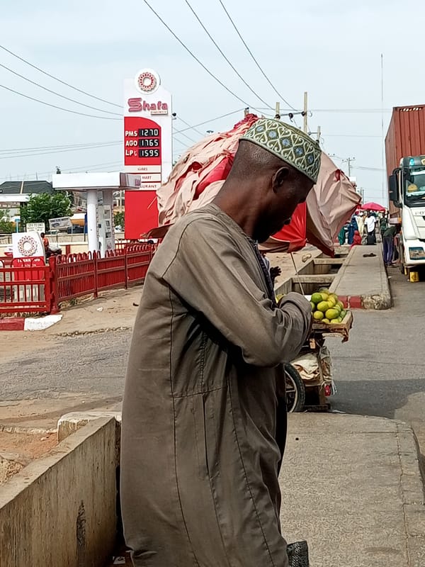 Vendors, shoppers, and street traffic at a busy urban market