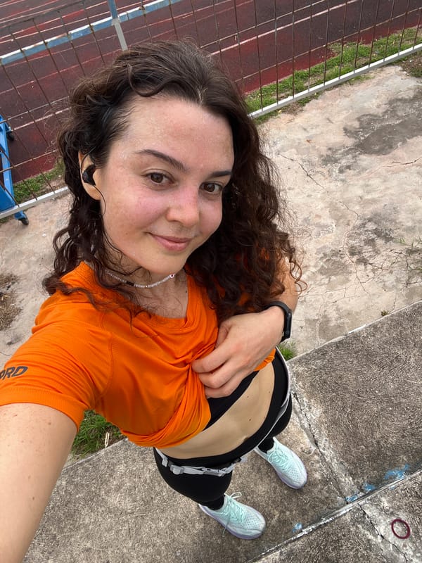 Post-run selfies on a Phan Thiết track, church in the background