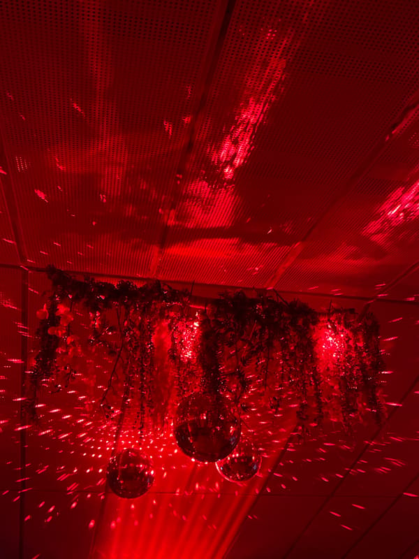 Red-lit interior with disco balls captured in Thailand