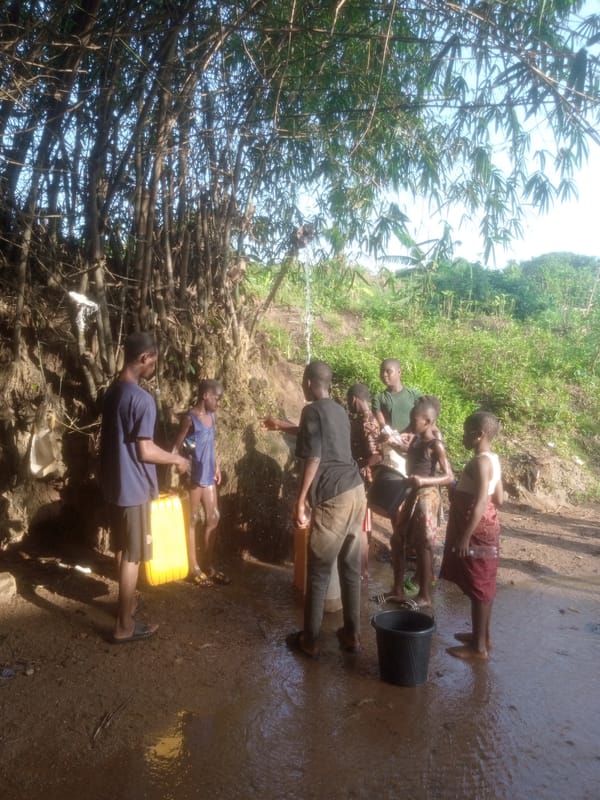 Community gathers at rural water source to fill containers