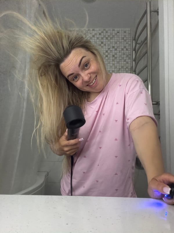 Woman's evening hair routine documented in Votkinsk bathroom