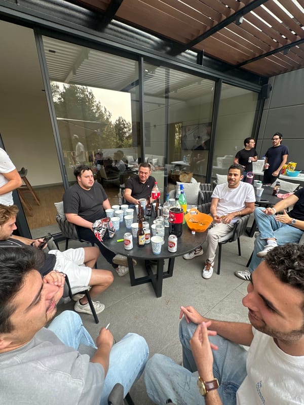 Nine young men gather around table in Mexican patio