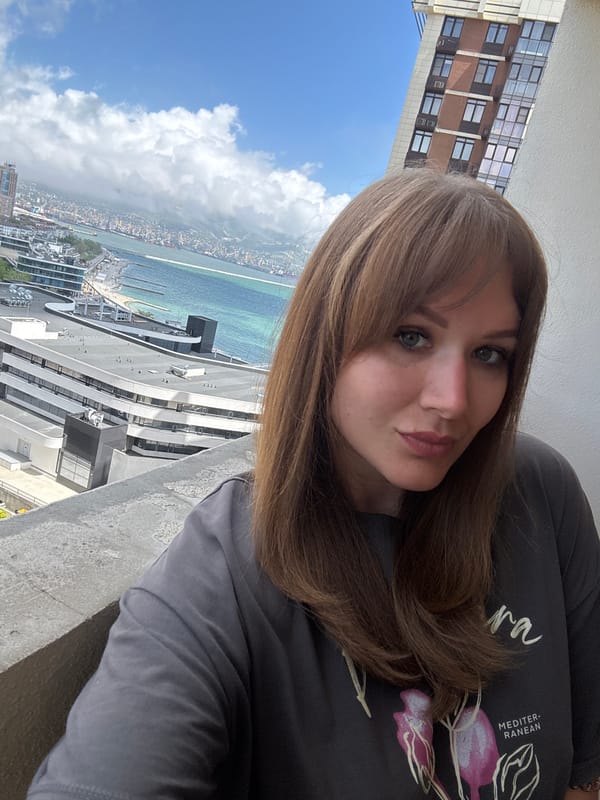 Woman observed on balcony overlooking Novorossiysk cityscape