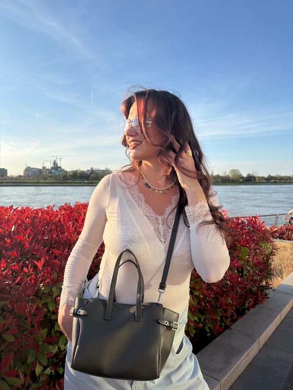 Two women smile together in bed in Belgrade