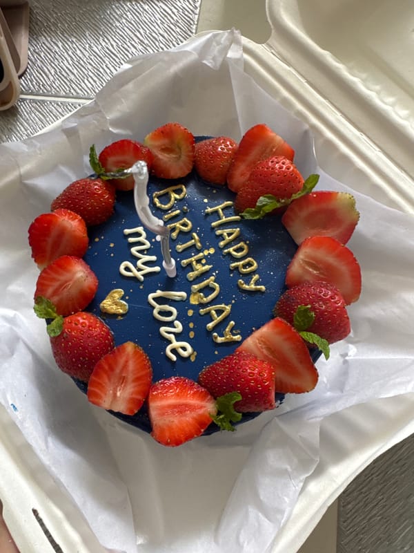 Birthday cake with personalized message observed in takeout container