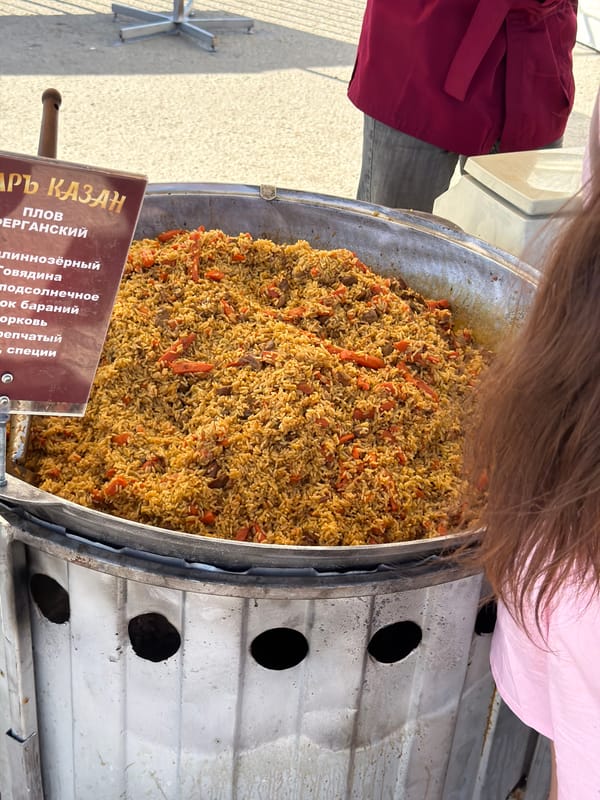 Food market bustling in Samara as vendors serve plov