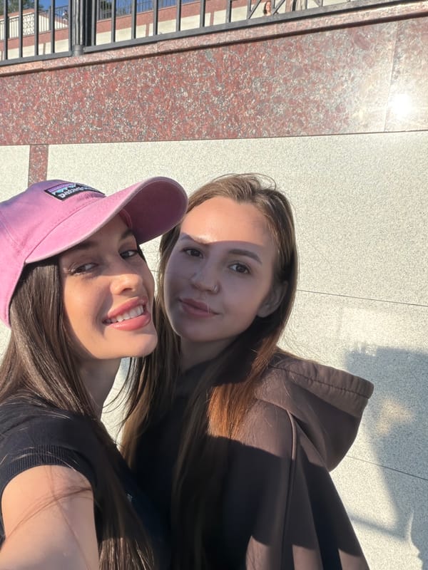 Woman documents sunny afternoon outing on Izhevsk waterfront promenade