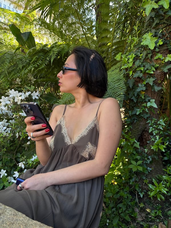 Woman enjoys outdoor refreshments in Santiago de Compostela garden