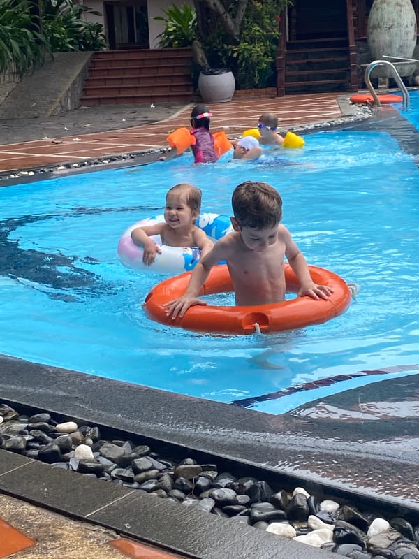 Children swim in residential pool early morning Vietnam