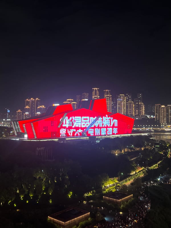Red-lit civic building stands out in Chongqing's night skyline