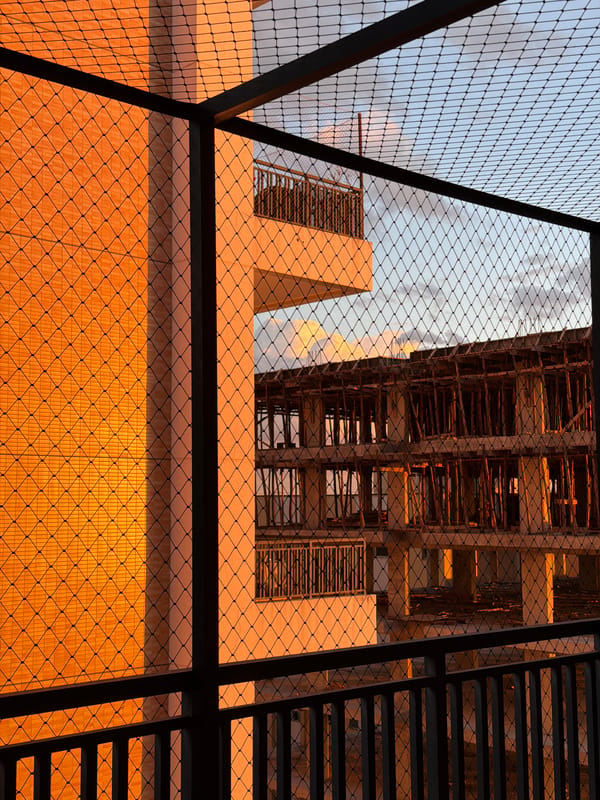 Wire fence frames modern architecture in evening Brasília