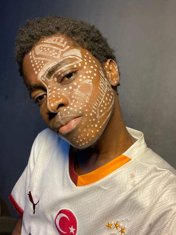 Traditional face paint observed on soccer fan in Nigeria