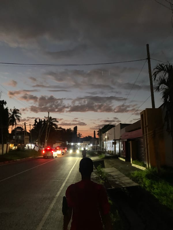 Dusk settles over a Dar es Salaam street and fruit stand