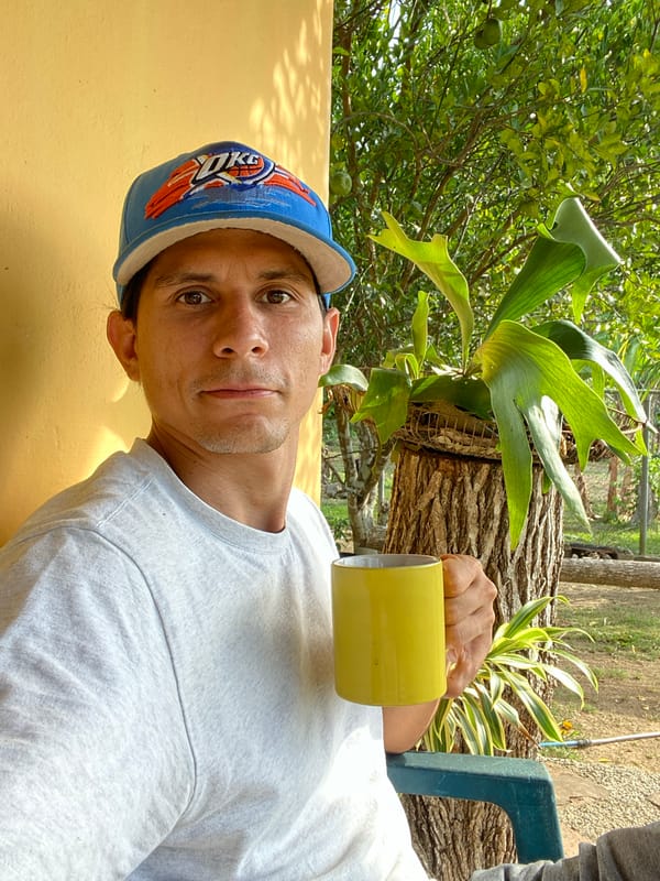 Man enjoys outdoor moment with coffee in Venezuelan neighborhood