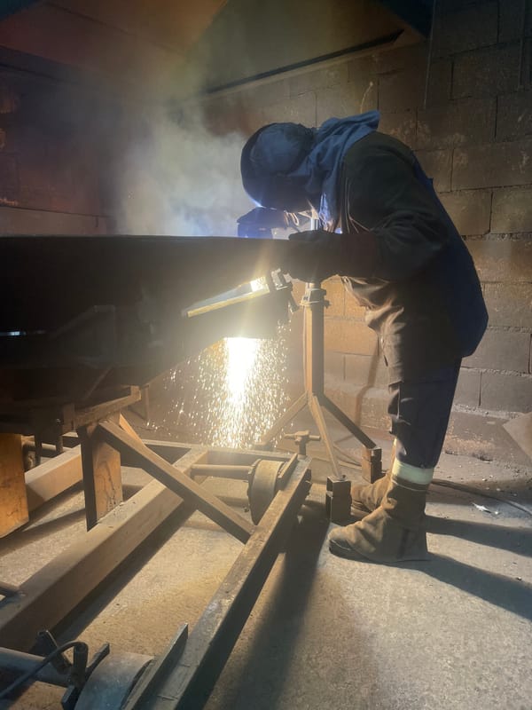 Welder performs metal work in Montenegro industrial workshop