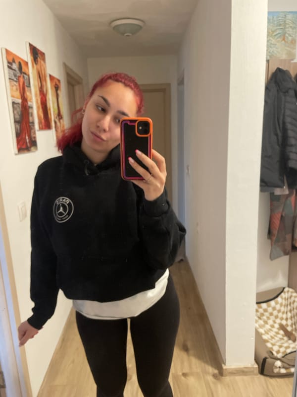 Woman takes mirror selfie in black athletic wear in Bulgaria