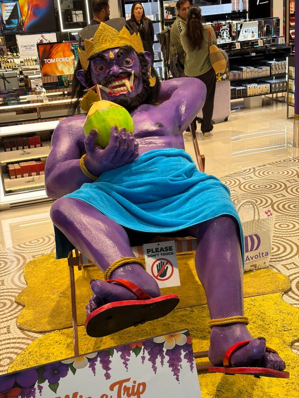 Demon statue chills on a beach chair in Kuta