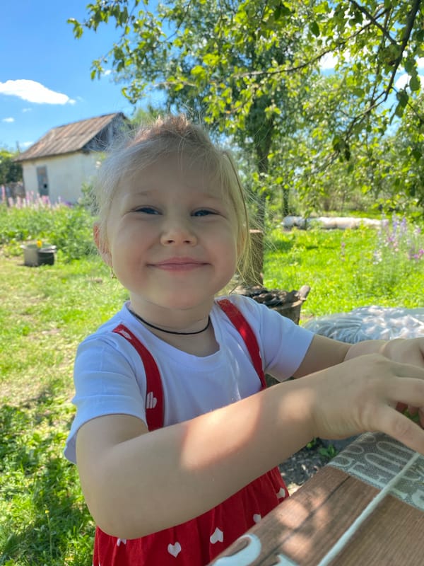 Summer morning in a Mariupol garden: peas, flowers, and play