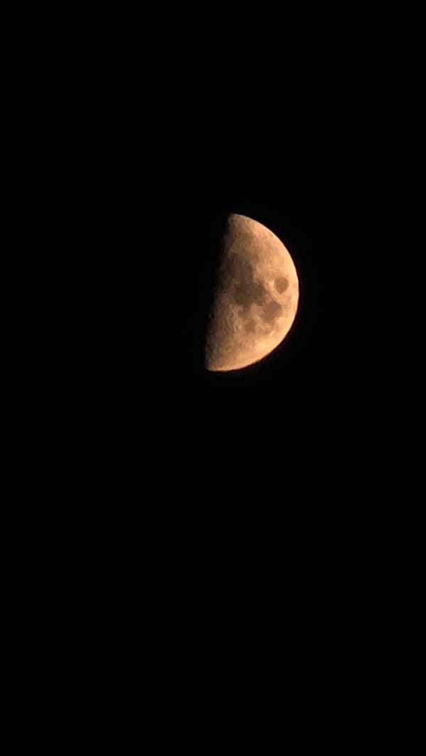 Kyiv neighborhood drifts from golden dusk into crescent moonrise
