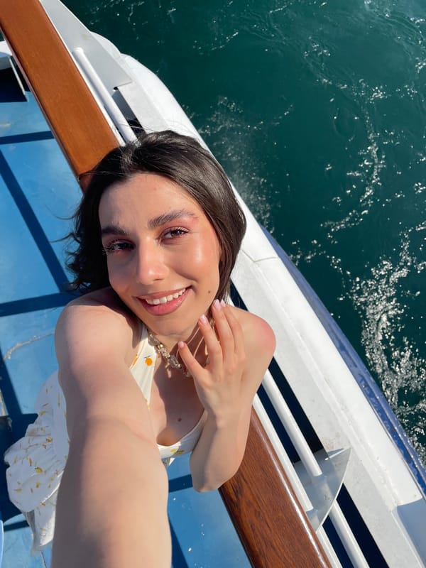Women take selfies on boat near Colonno, Italy